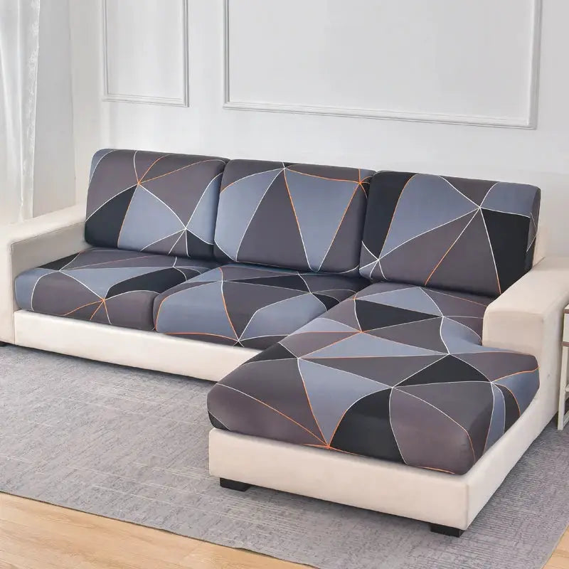 L-shaped sectional sofa covered with blue-gray geometric print stretch slipcovers and matching chaise cushion