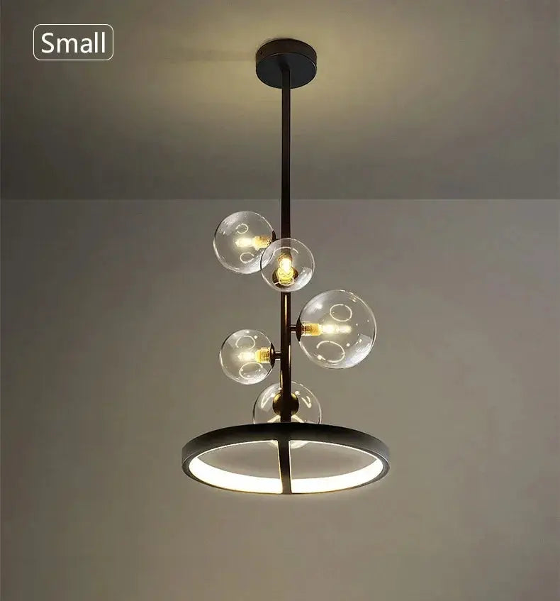 Modern art glass chandelier by Simples Market with a black metal stem and clear glass globes around a circular LED ring