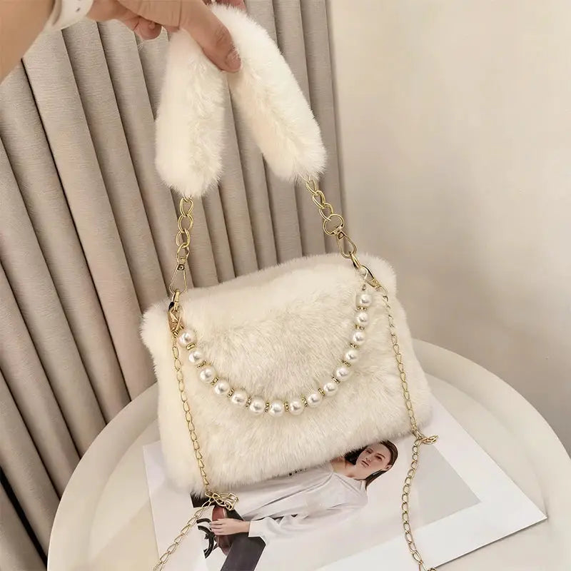 White faux-fur handbag with pearl bead strap and gold chain crossbody strap