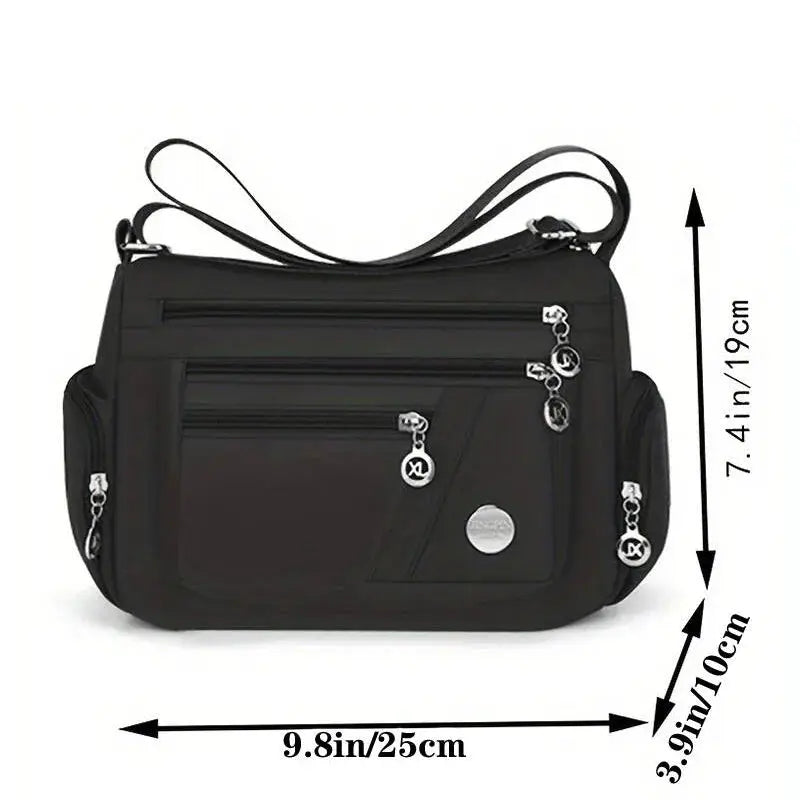 Crossbody bag by Simples Market in black nylon with multiple zip compartments and adjustable strap