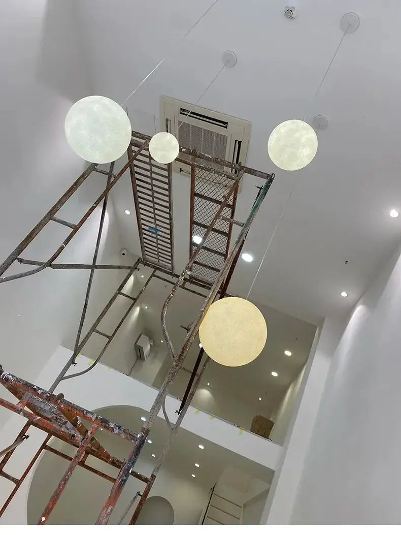 Nordic Moon LED pendant lights; four white globe pendants on suspended cords
