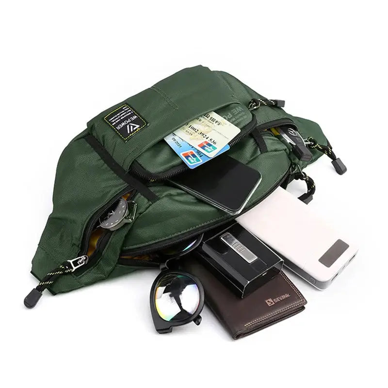 Men's green nylon waist pack with multiple zip pockets; phone, cards, wallet and sunglasses spilling out.