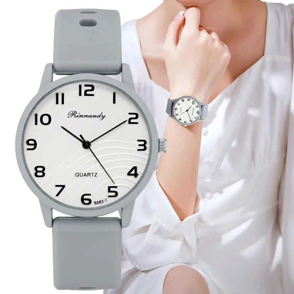 Women's quartz watch by Rinnandy with gray silicone band and Arabic numeral dial; two watches shown