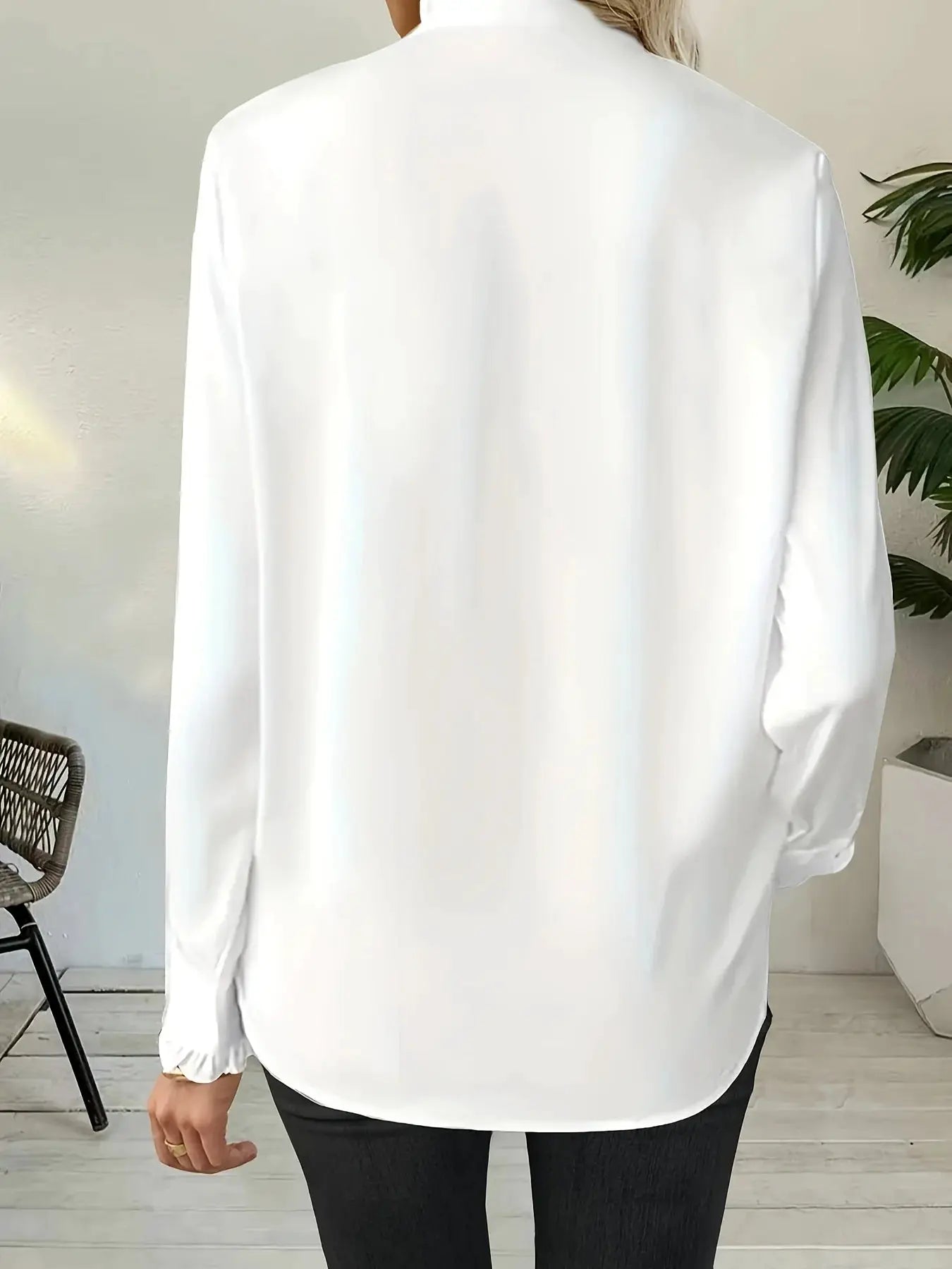 Loose white women's long-sleeve blouse, back view