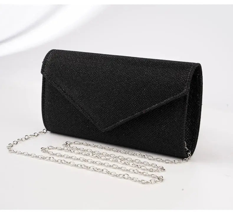 Envelope evening bag for women in black glitter with silver chain strap.