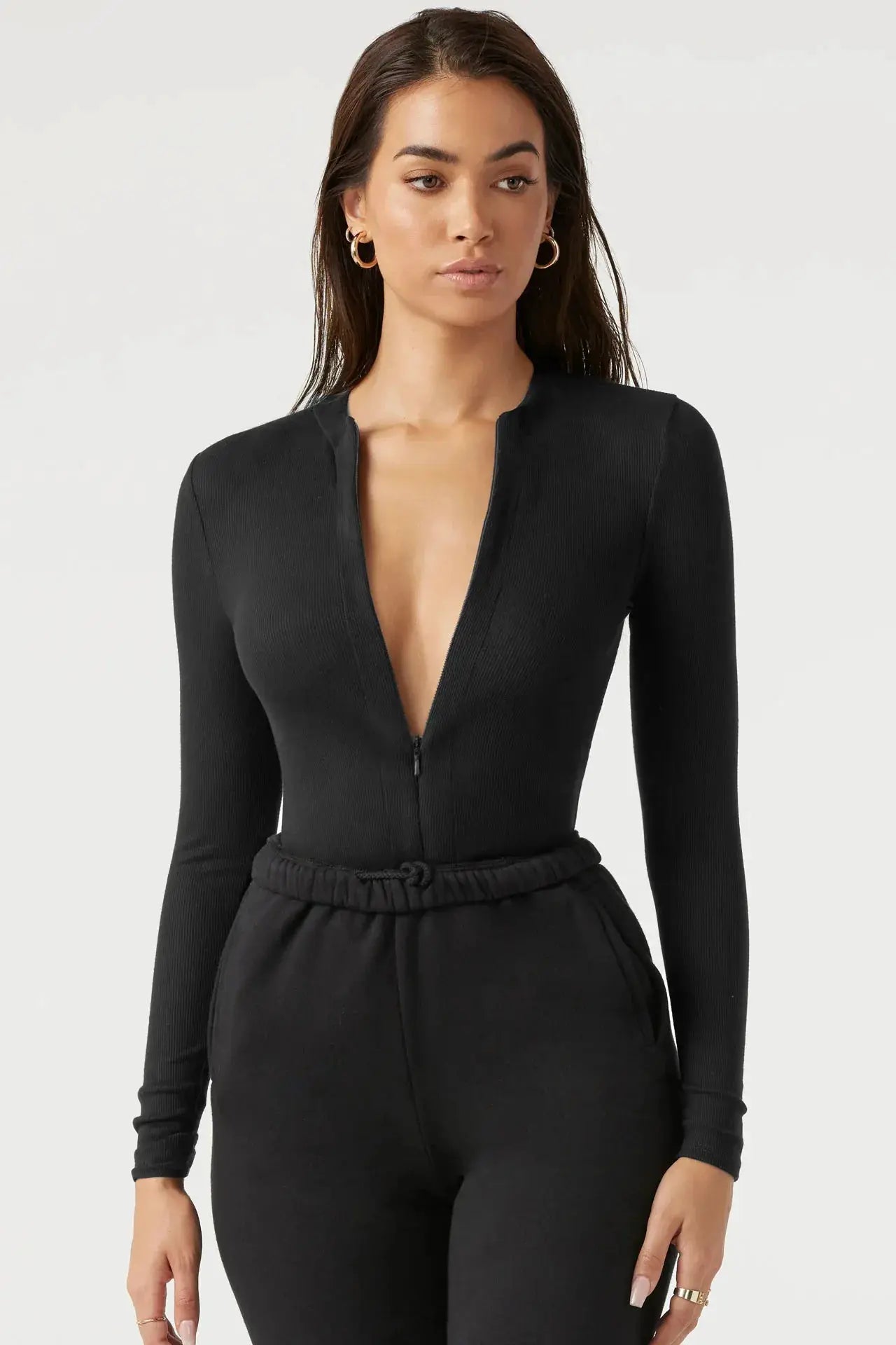Women's black knit jumpsuit with zipper top, long sleeves, elastic drawstring waist