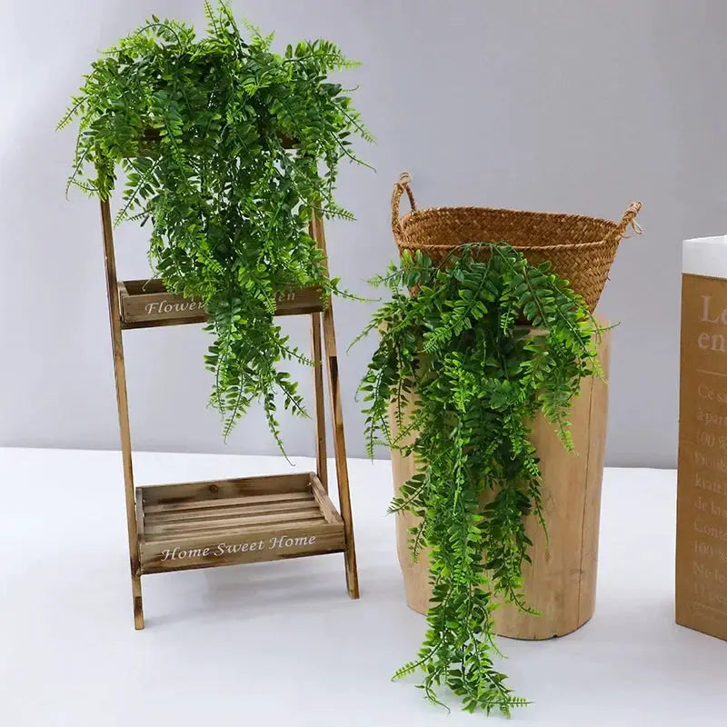 90cm artificial plant vine with green plastic leaves, draped over a wooden ladder and wicker basket.