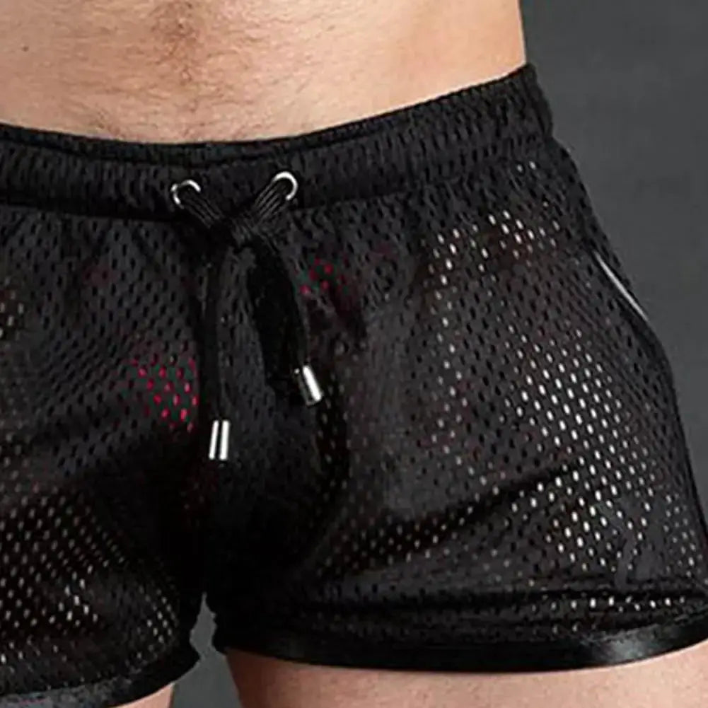 Men's black mesh sport shorts with drawstring, quick-dry perforated fabric.