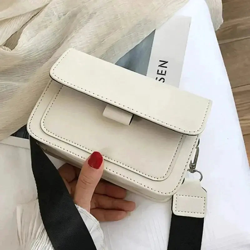 Simples Market women’s PU leather crossbody bag in cream with a small front flap and black adjustable strap