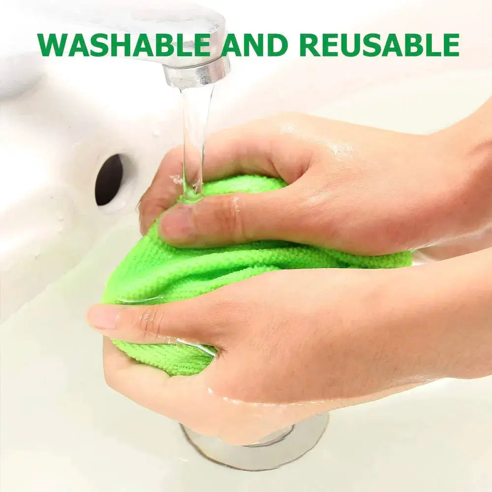 Microfiber car window cleaning cloth, green, being wrung under running water
