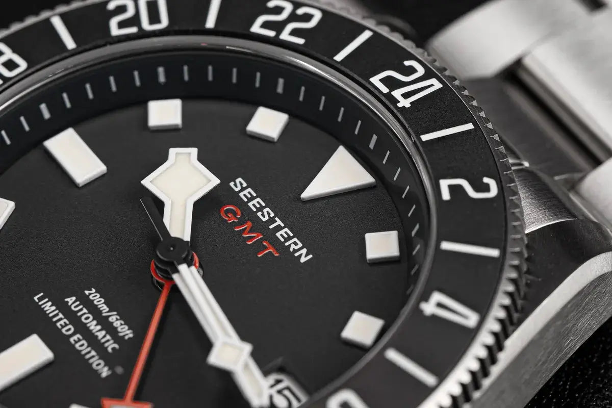 Seestern Diver GMT watch with black dial, white lume indices, red GMT hand, and 24-hour bezel