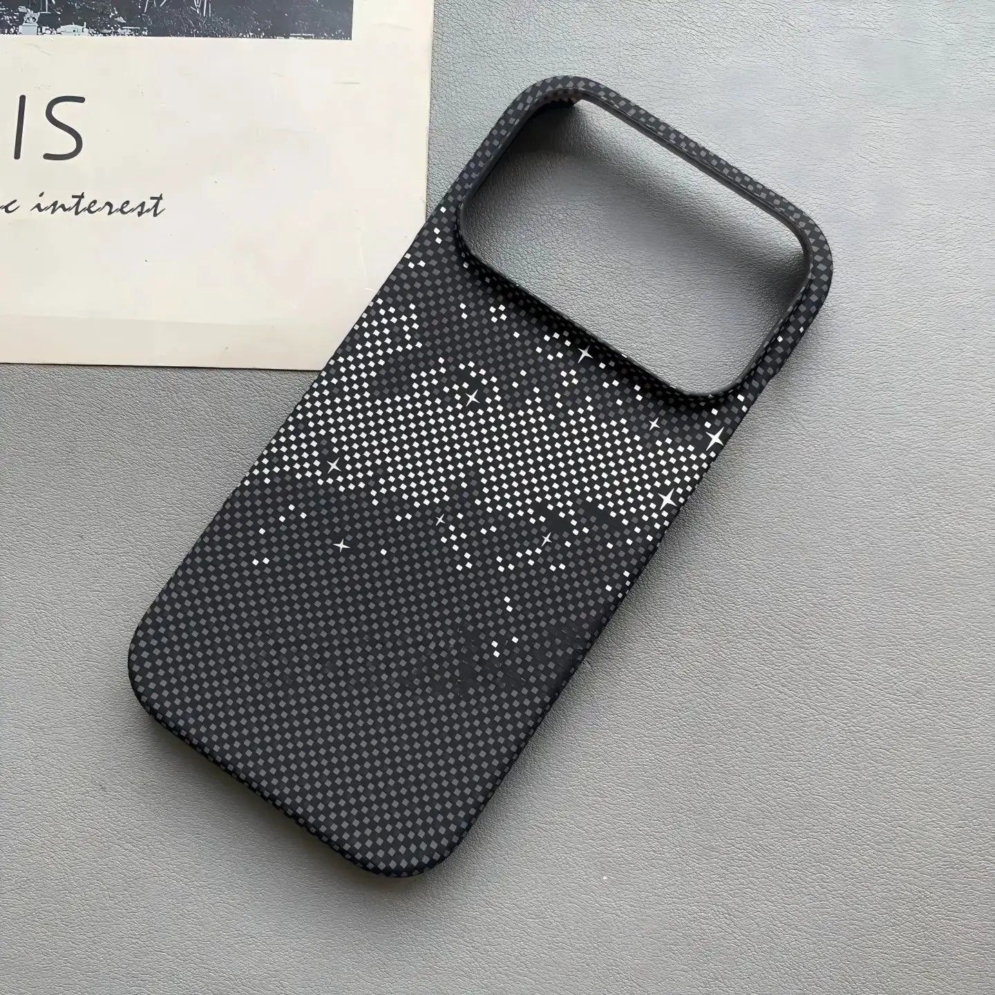Frameless carbon fiber MagSafe phone case for iPhone, black dotted texture.
