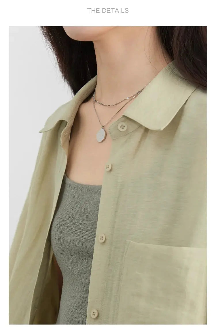 CHIC VEN women's long-sleeve beige button-front shirt with chest pocket, layered over a gray knit tank.
