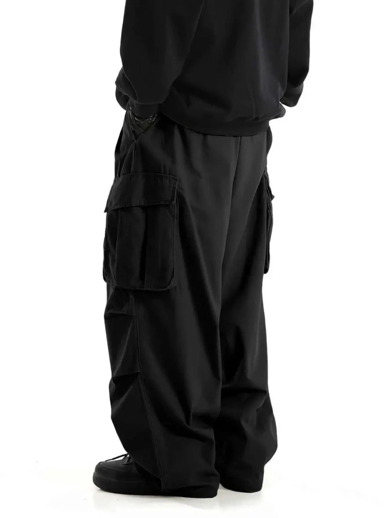 Plus size men's black cargo workwear pants with wide legs and large side cargo pockets.