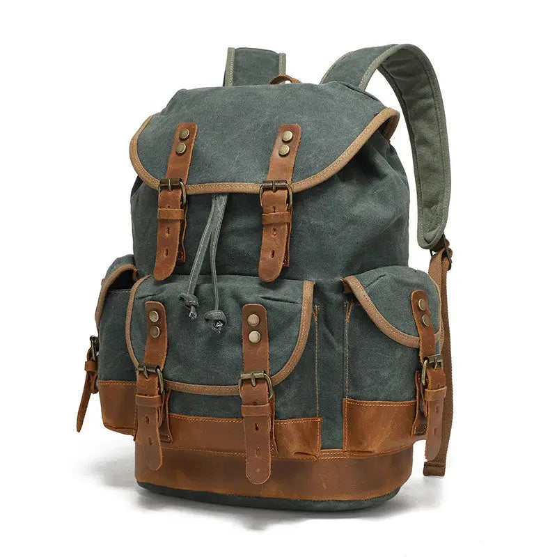 Vintage canvas backpack in green with brown leather straps and front buckle pockets