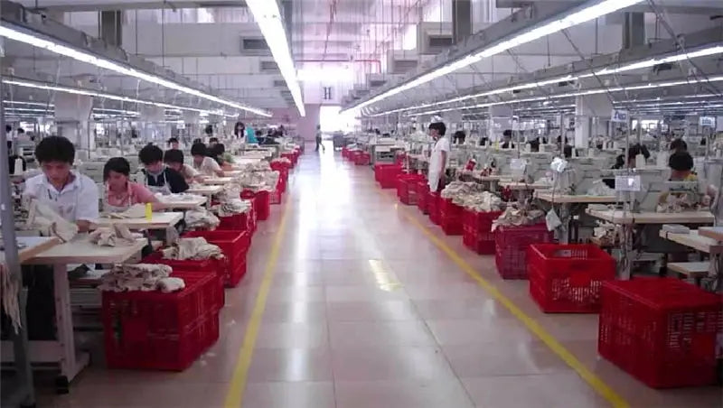 Women's casual tops by Simples Market on a factory production line with workers sewing