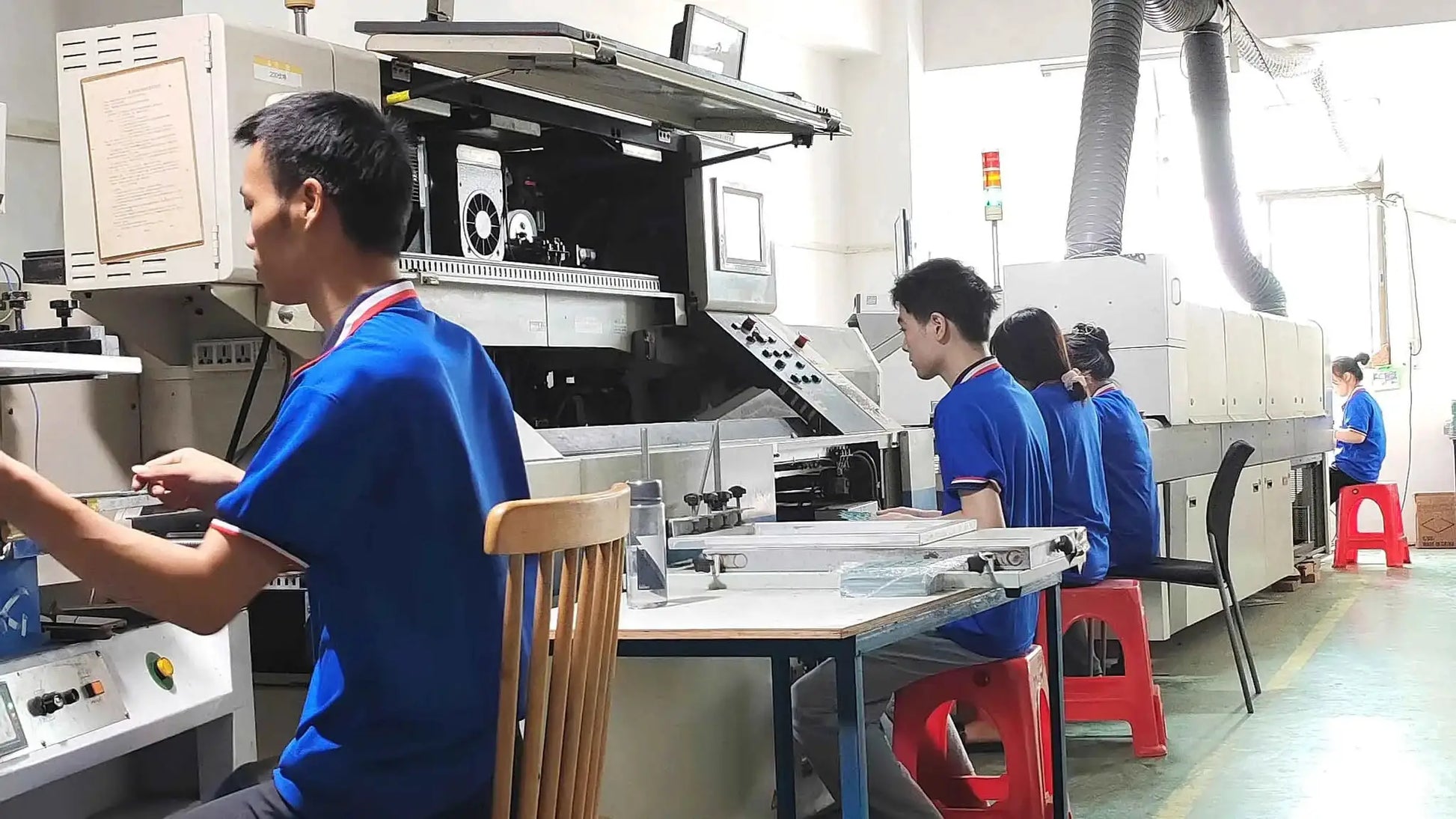 MANMU 120mm rainbow RGB case fans on a factory assembly line with workers
