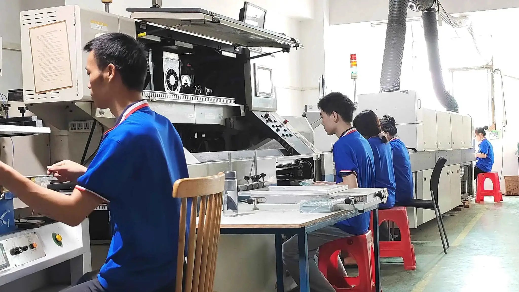MANMU 120mm rainbow RGB case fans on a factory assembly line with workers