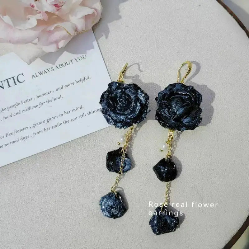 Elegant Immortal Rose Long Earrings by Simples Market; dark navy epoxy roses with gold hooks and dangling stones 2 pcs