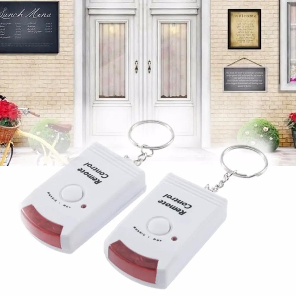 Simples Market wireless motion sensor alarm set, 2 white indoor/outdoor detectors on keychains with red lenses