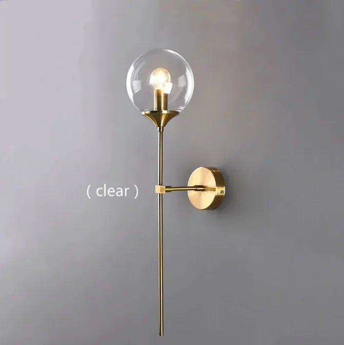 Modern glass wall lamp with brass finish and clear globe shade; wall-mounted Nordic sconce.