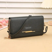 Women’s mid-size wallet bag by Simples Market in black with convertible shoulder strap and gold hardware