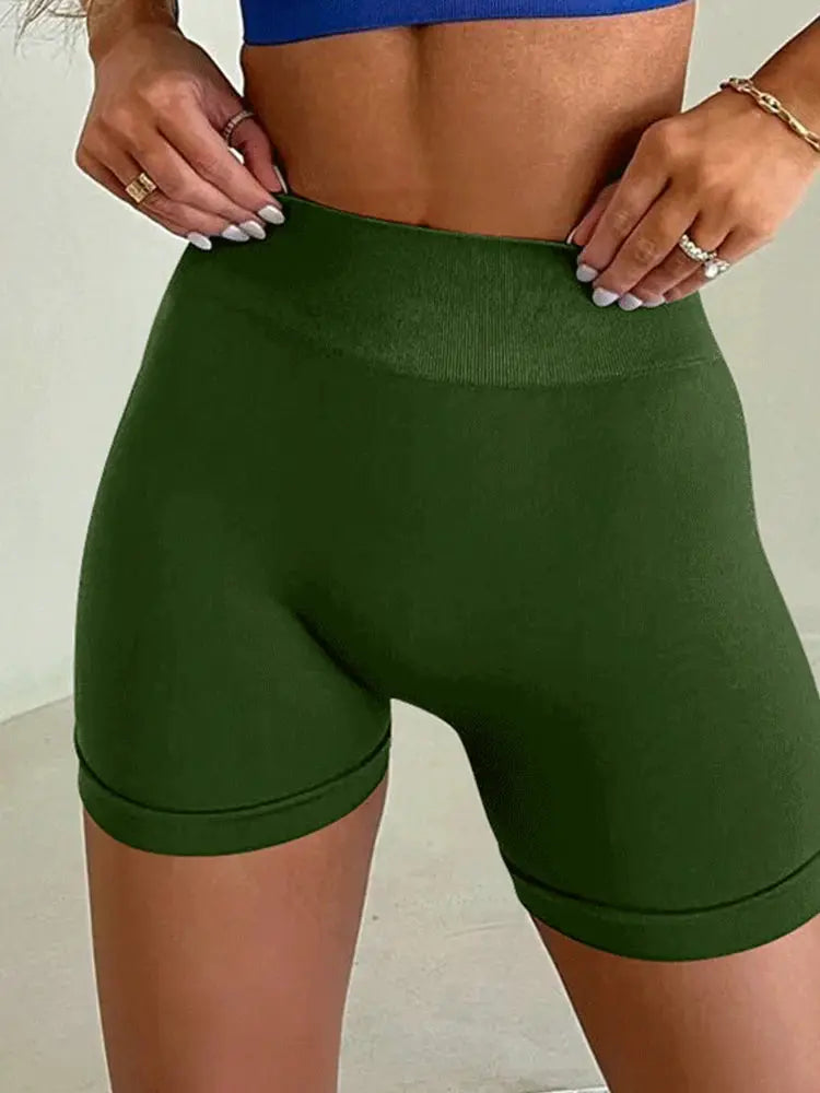 Women's high-waisted green seamless yoga shorts for workouts and training.