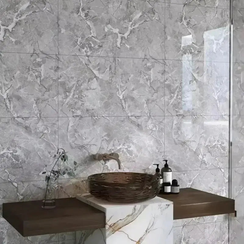 Marble-look self-adhesive wall tiles in gray and white on a bathroom wall