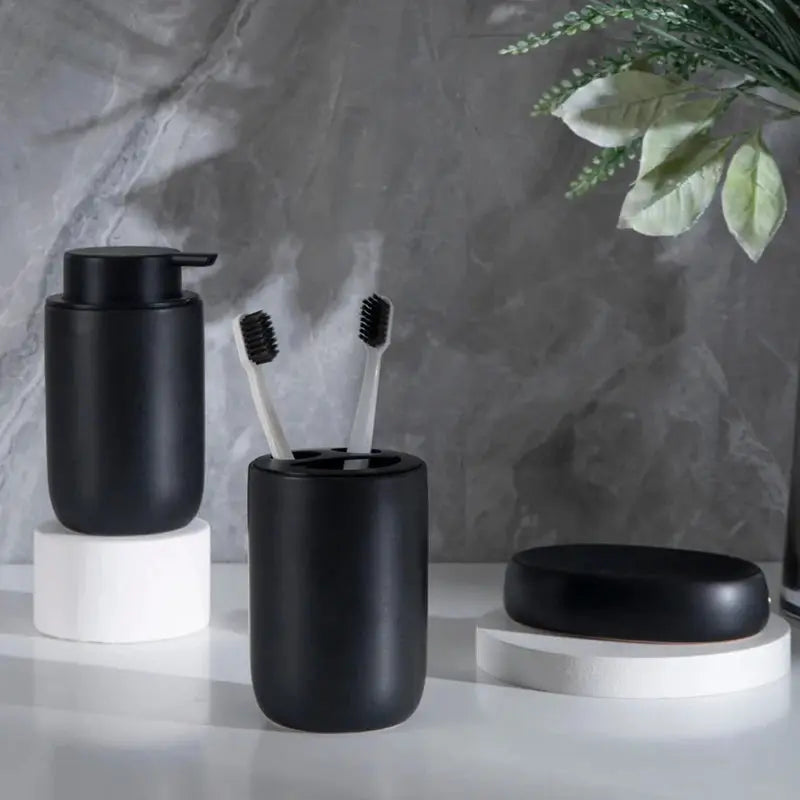 Bathroom set in matte black ceramic: pump bottle, toothbrush holder with two brushes, soap dish (3-piece)