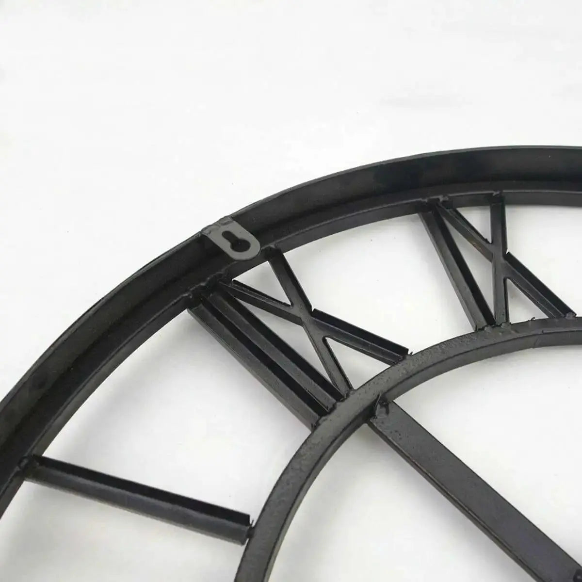 Round black metal wall clock frame with geometric support spokes and hanging loop