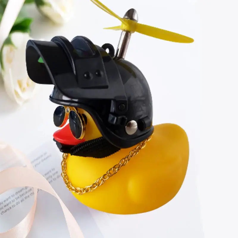 Yellow rubber duck car ornament with a black helmet, sunglasses, and gold chain