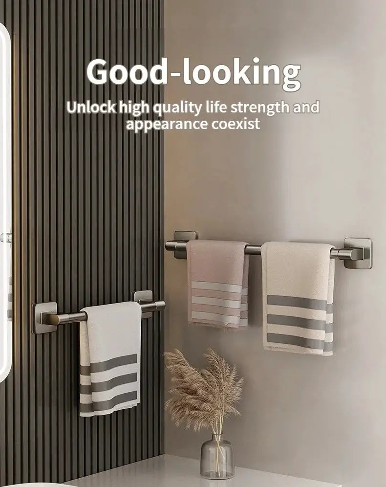 No-drill wall-mounted towel rack by Simples Market with three brushed-metal bars and white, pink, beige towels.