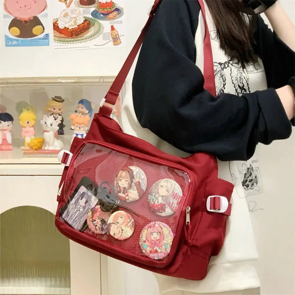 Simples Market red Ita bag with clear window, adjustable strap, multi-pocket design and anime character pins.
