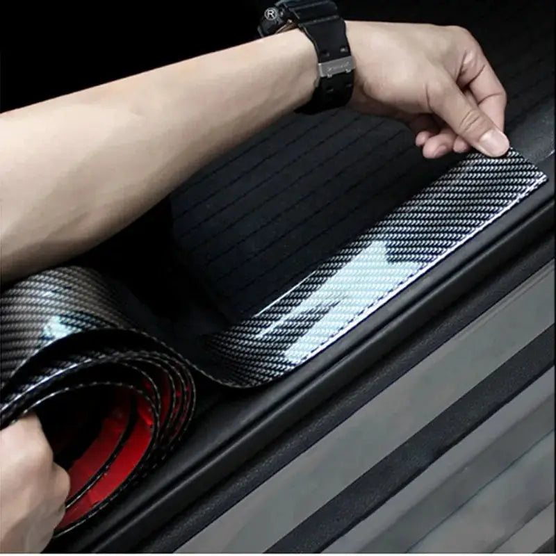 Carbon fiber car spoiler wrap, 1.5M 5D vinyl, being installed on a trunk edge.