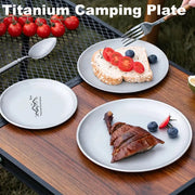 Three titanium camping plates by Simples Market, frosted round reusable tableware for outdoor dining.