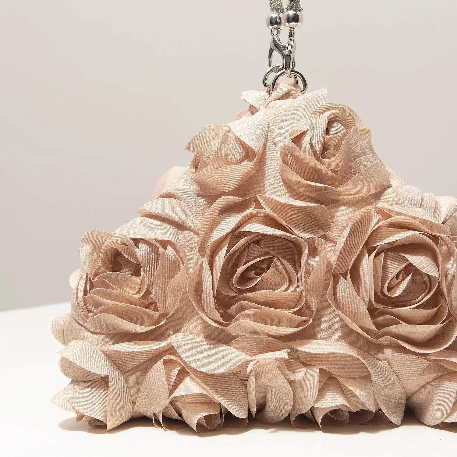 Mini blush pink fabric rose purse with silver chain, ideal for bridal party or prom.