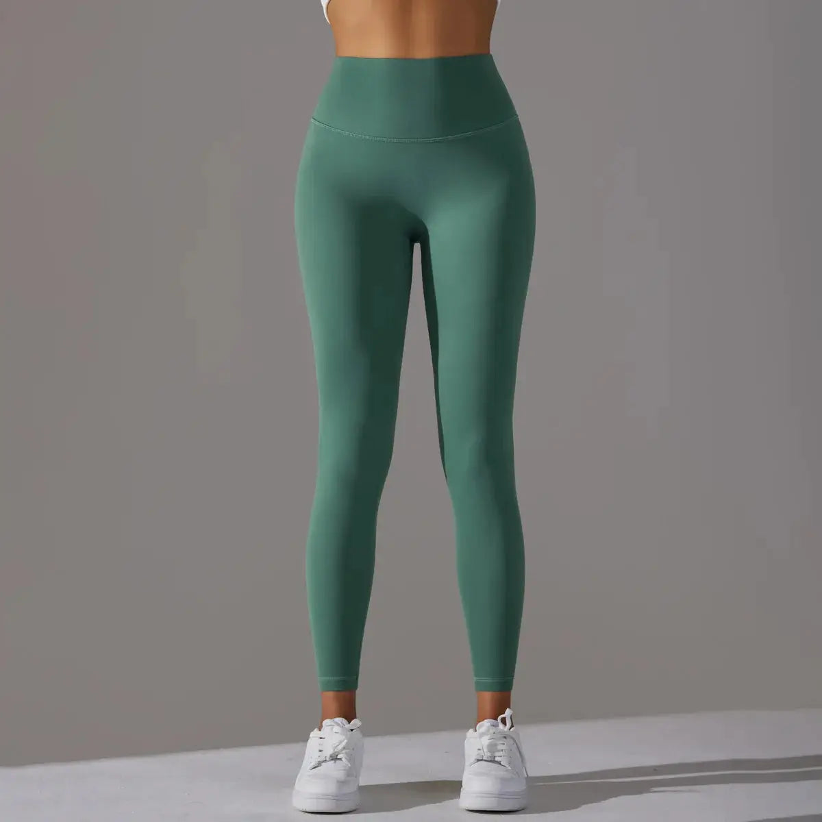 High waist green leggings for fitness and yoga with a tight, flattering fit