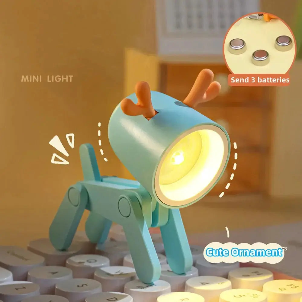 LED mini night light in a blue animal desk lamp with orange antlers and foldable legs on a keyboard