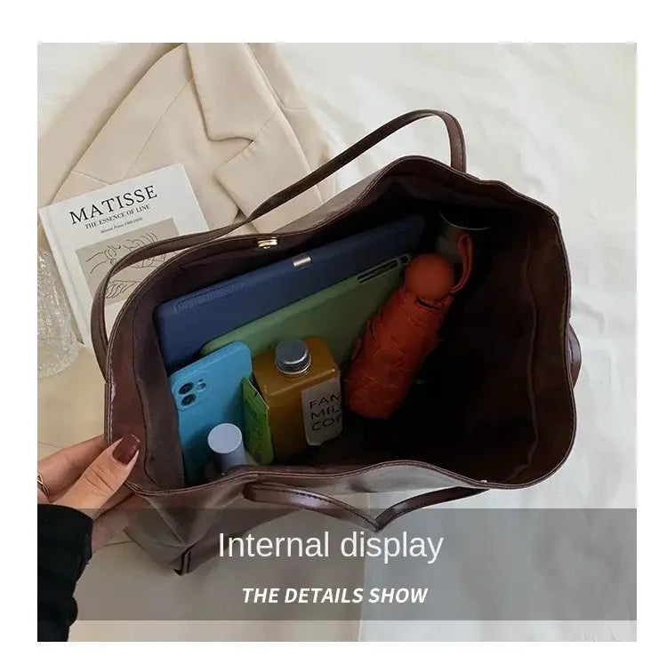 Women tote bag by Simples Market, brown PU leather; large-capacity bucket style with interior items like phone and umbrella.