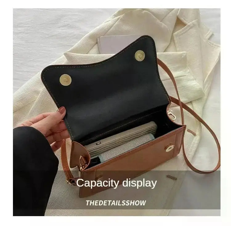 Brown PU leather handbag crossbody bag with flap, gold snap closures and black interior