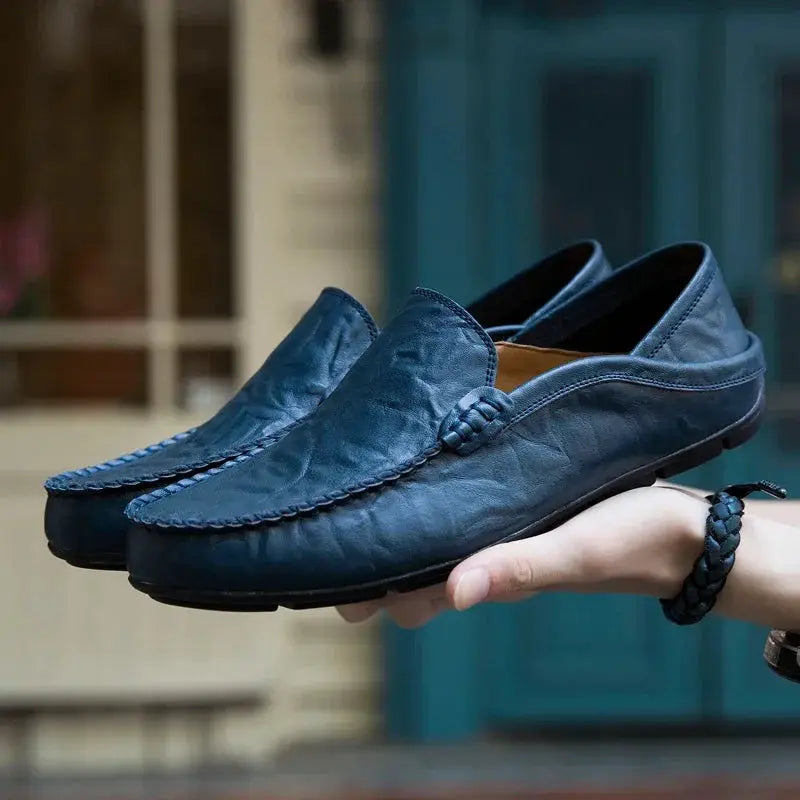 Pair of blue men's genuine leather loafers with moccasin stitching, slip-on casual shoes