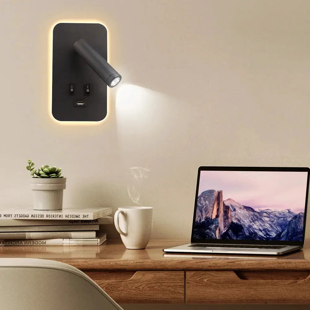 Chargeable USB wall lamp with rotatable head, black matte finish, warm LED glow and built-in USB port.