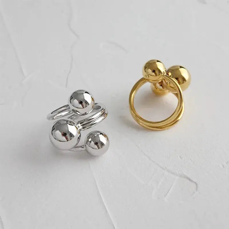Two-tone punk metal ring set: silver three-ball stacked band and gold double-ball ring, adjustable.