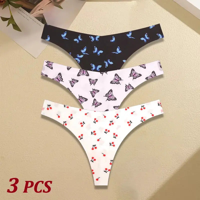 3-pack women's seamless thongs in black with blue butterflies, white with pink butterflies, and white with red cherries