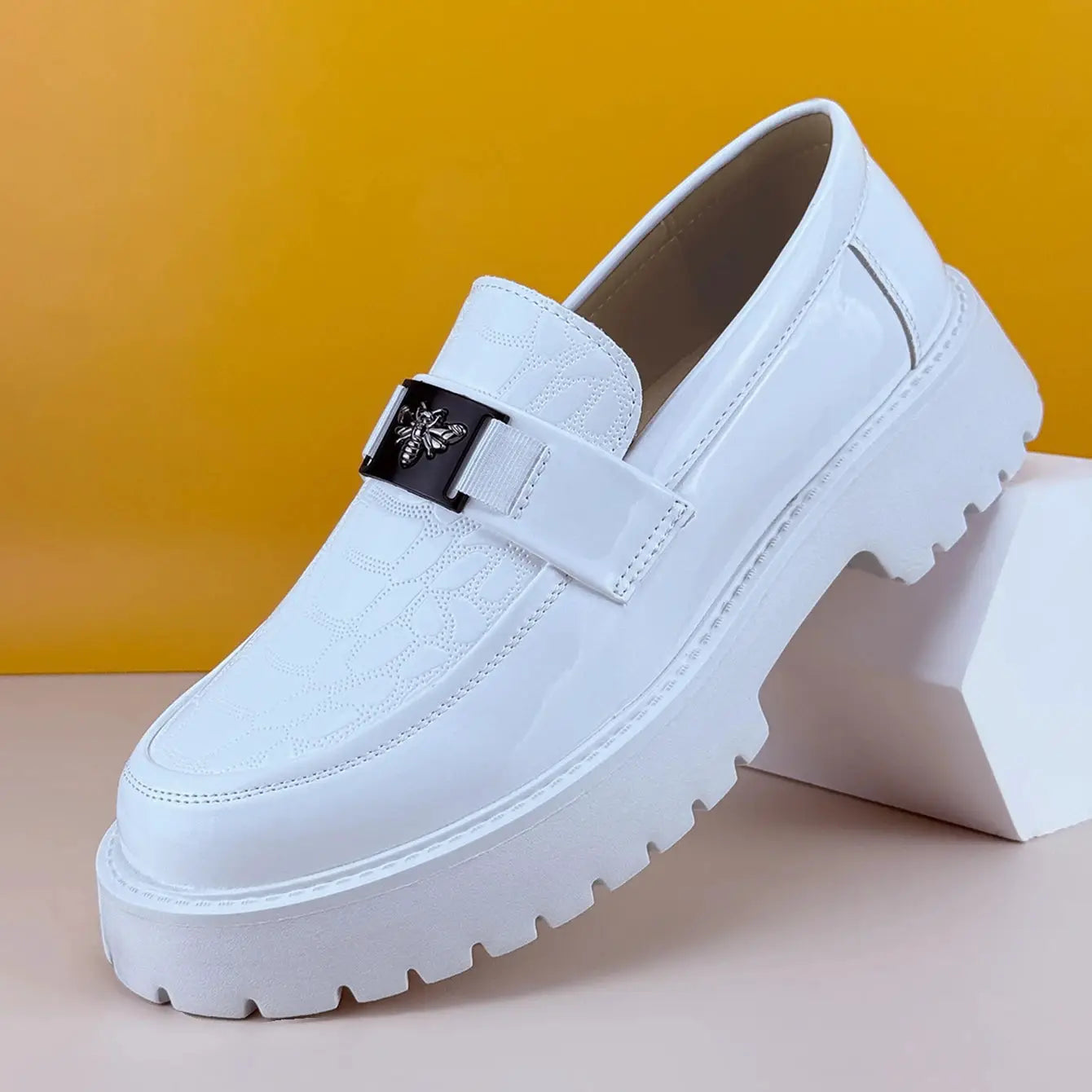 Men's white leather loafers with thick lug sole and bee buckle strap