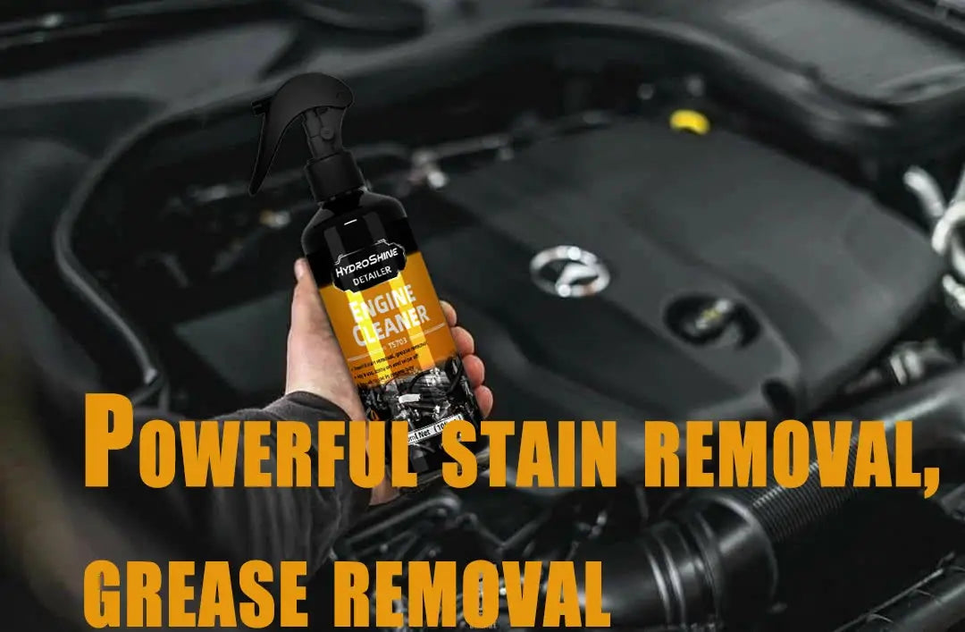 Engine cleaner spray bottle by Simples Market, black bottle with orange Hydroshine label held over a car engine bay