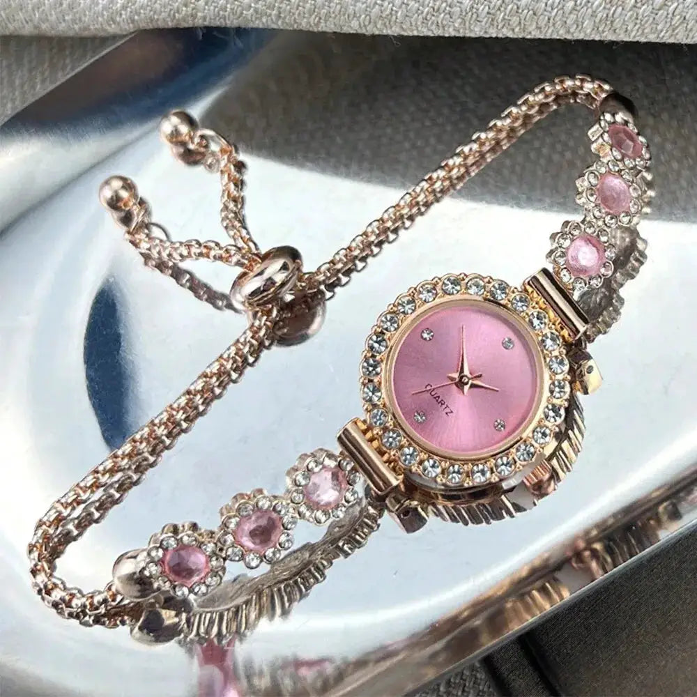 Women's pink-dial quartz watch with rose-gold case, rhinestone bezel, and floral pink-stone bracelet.