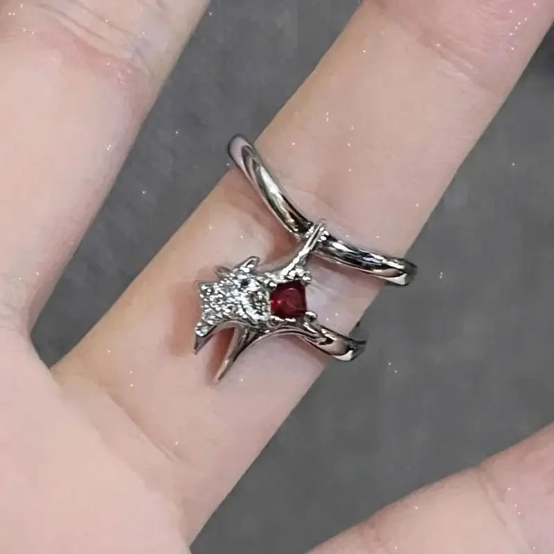 Set of two silver-tone open rings featuring a star crystal cluster and red gemstone centerpiece