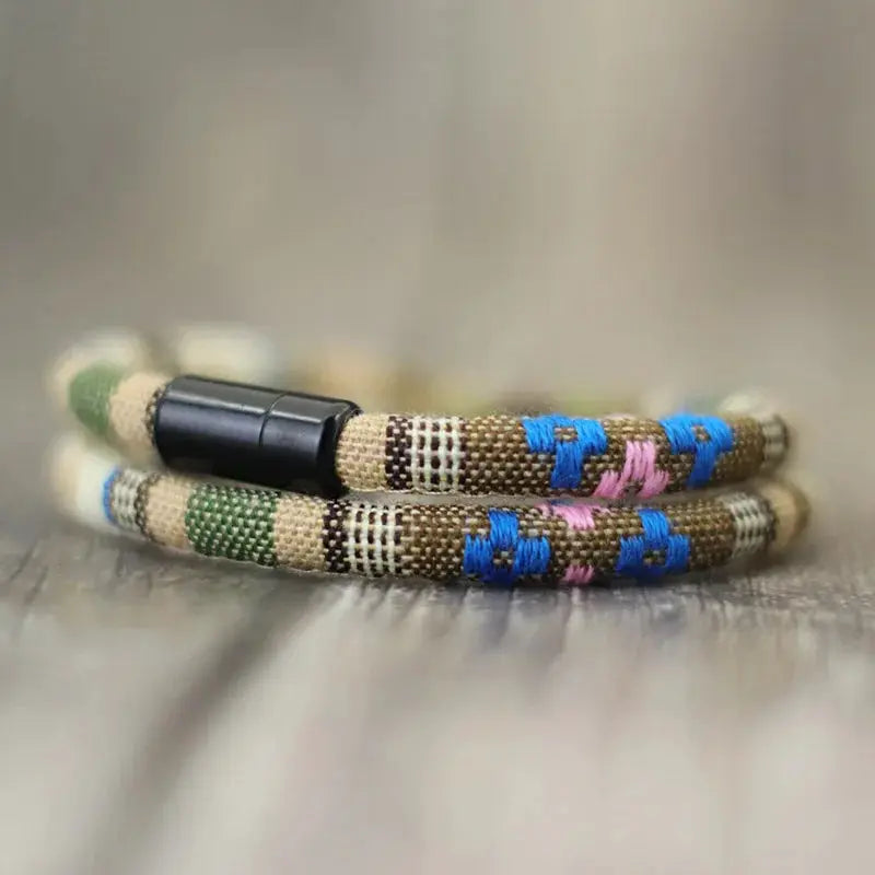 Pair of men's Bohemian rope bracelets with magnetic clasps; tan cords with blue and pink woven accents.