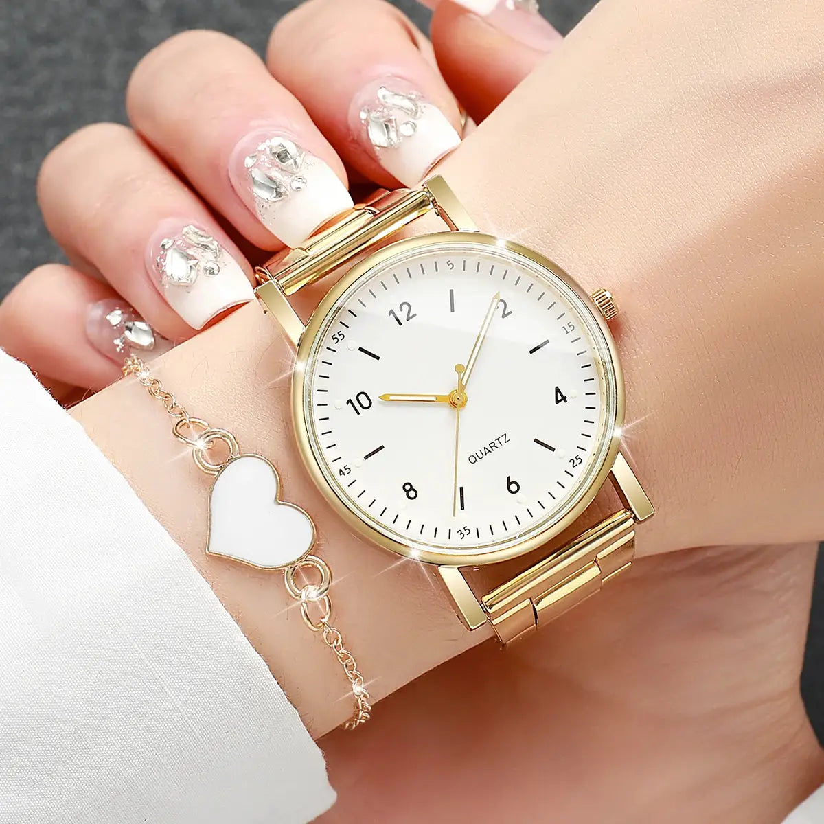 Gold-tone wristwatch with white dial and black Arabic numerals; 2-piece watch and bracelet set